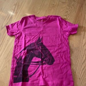 A pink tee shirt with a horse on it
